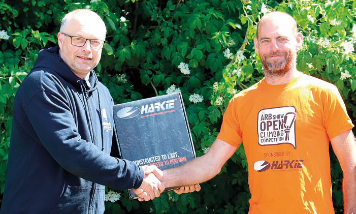Paul McBride receiving his ARB Show Open Tree Climbing Competition winner’s prize from Mark Hemming, Association Technical Officer.